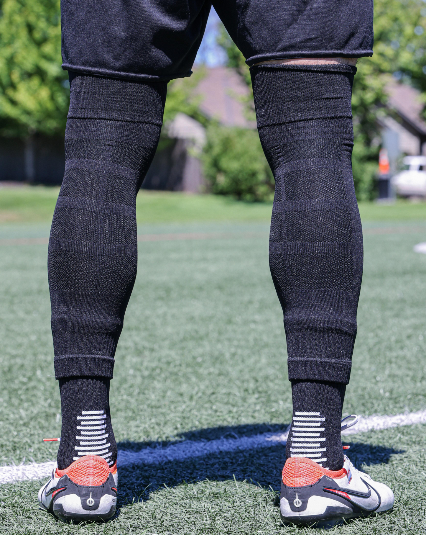 SL FLEX Sock Sleeve Black Back View Standing With Cleats