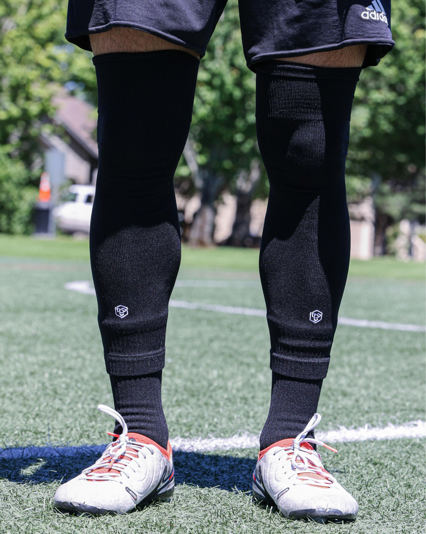 SL FLEX Sock Sleeve Black Front View Standing With Cleats