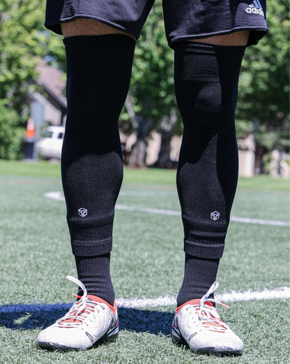 SL FLEX Sock Sleeve Black Front View Standing With Cleats