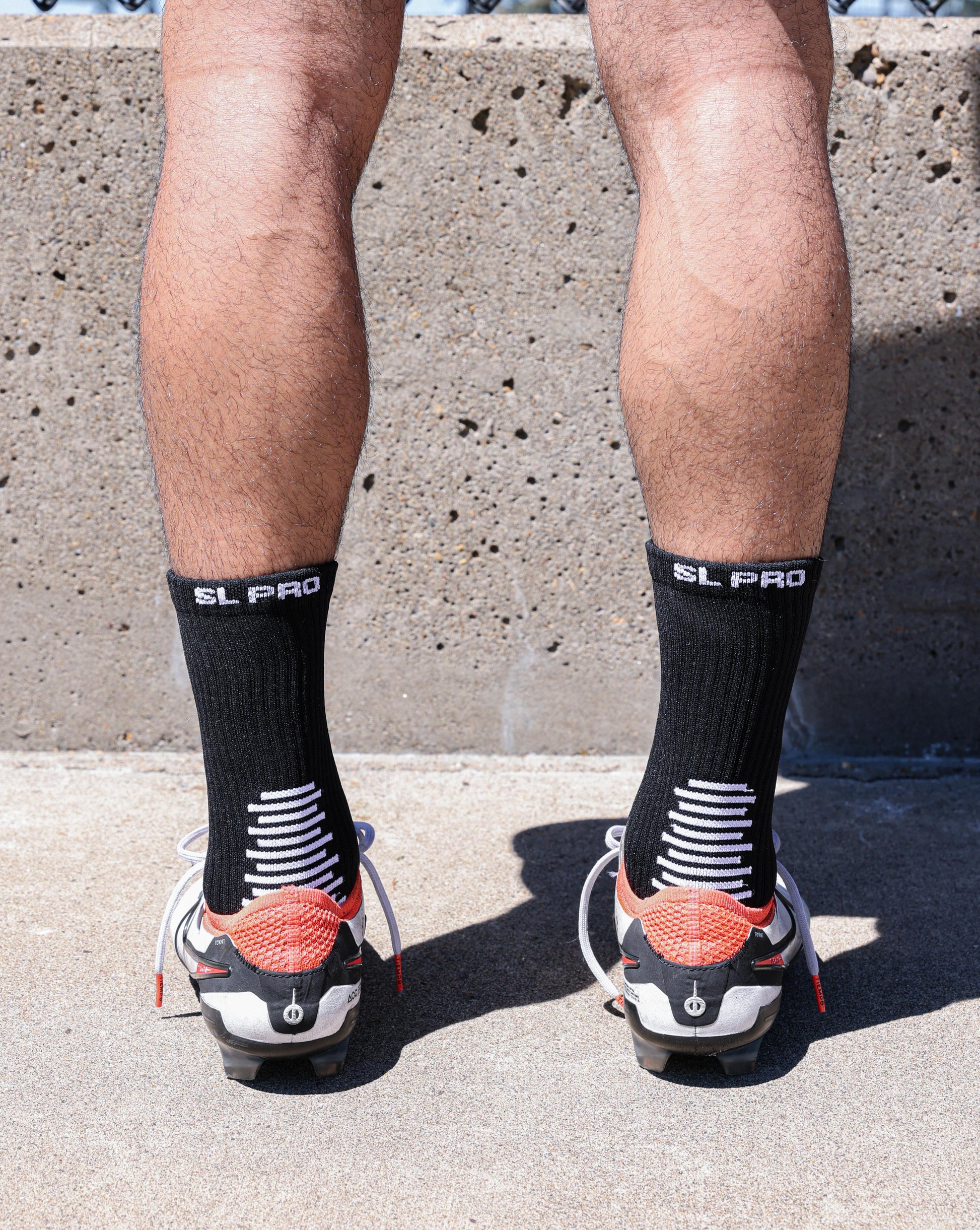 SL PRO Grip Socks Black Back View Standing with Cleats