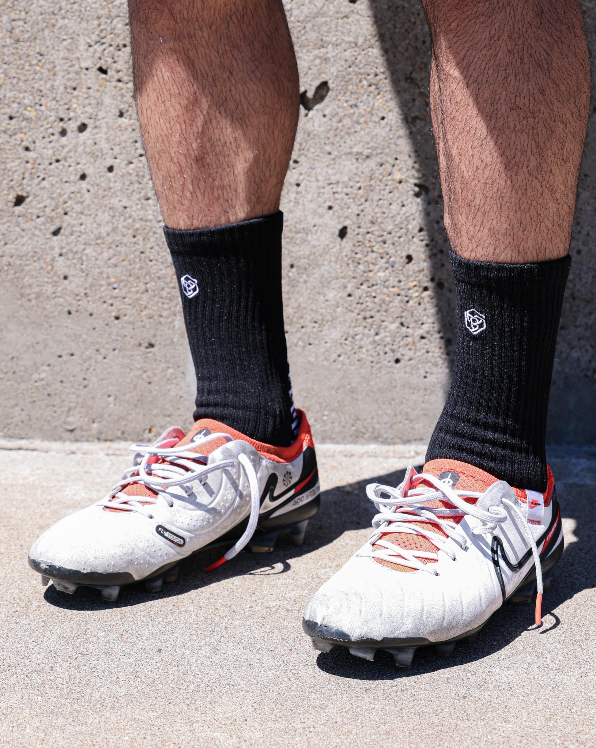 SL PRO Grip Socks Black Front View Standing with Cleats Side